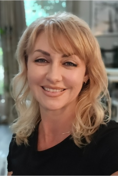 Portrait of a woman with blonde hair wearing a black top